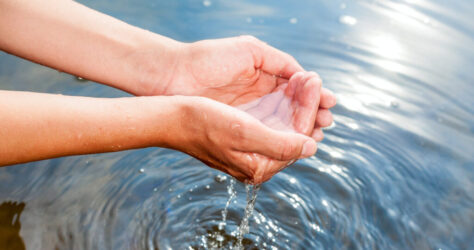 hands dipping in water